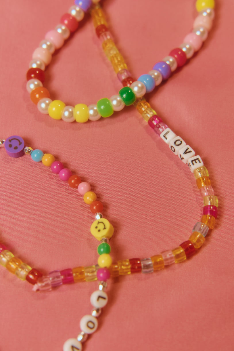 Multicolored Bead Necklace on Pink Background